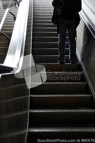 Image of Man moving up with escalator