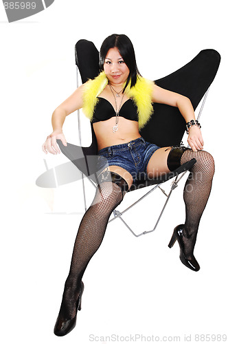 Image of Asian girl lying in a butterfly chair.