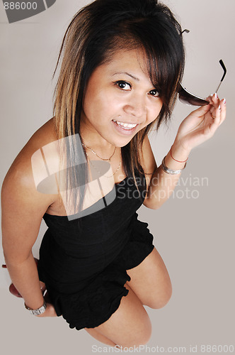 Image of Cambodian girl kneeling on floor.