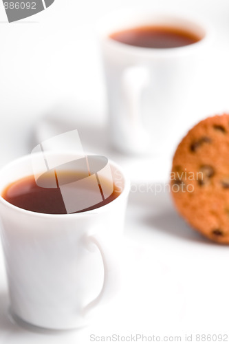 Image of two cups of coffee and muffin