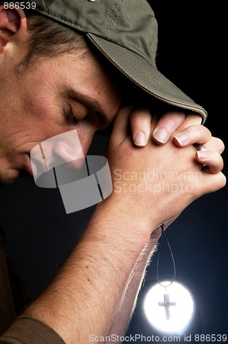 Image of Praying Man Holding A Cross