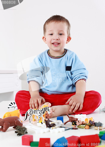 Image of Lovely boy playing with blocks