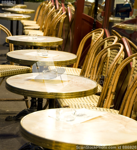 Image of night scene Paris France cafe setting tables chairs