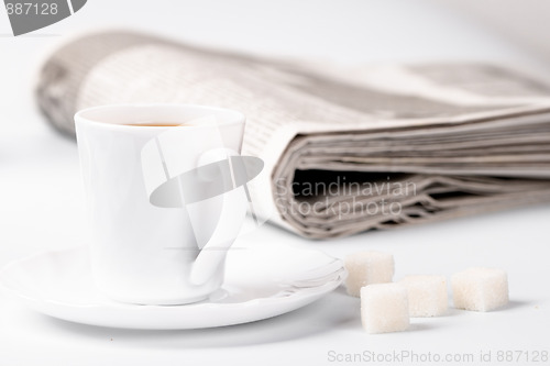 Image of cup of coffee, sugar and newspapers