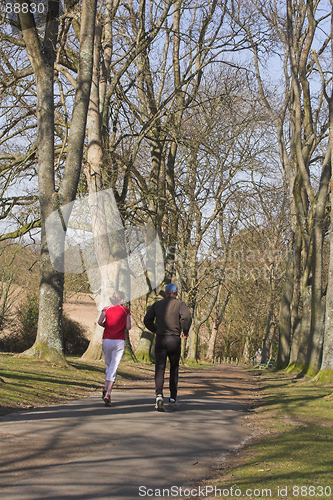 Image of Couple jogging through park