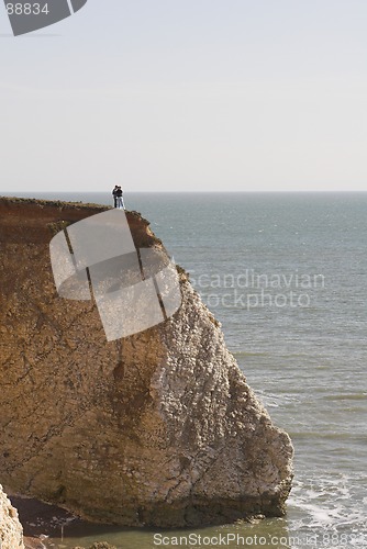 Image of Couple standing on cliff edge