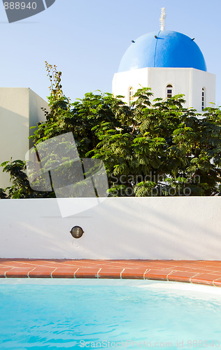 Image of swimming pool with classic Greek Island church Santorini Greece