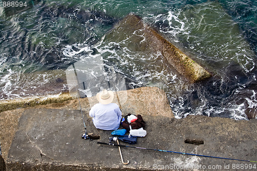 Image of Fisherman is fishing on the sea stone, top horizontal view 