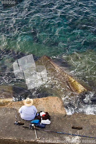 Image of Fisherman is fishing on the sea stone, top vertical view
