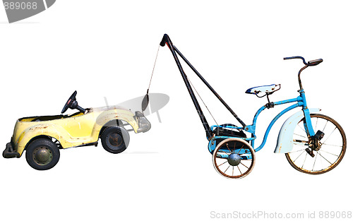Image of Trike with a Toy Car in Tow