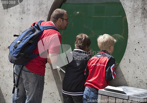 Image of Father and boys in zoo