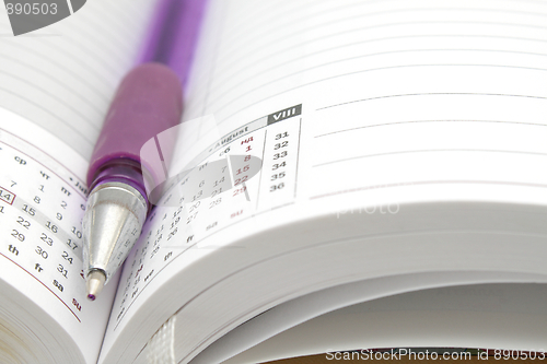 Image of Opened diary with a ball pen