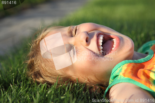 Image of Happy girl relaxing on a grass