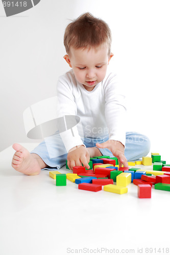 Image of Lovely boy playing with blocks