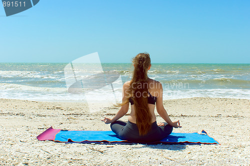 Image of woman meditating in yoga pose outdoors