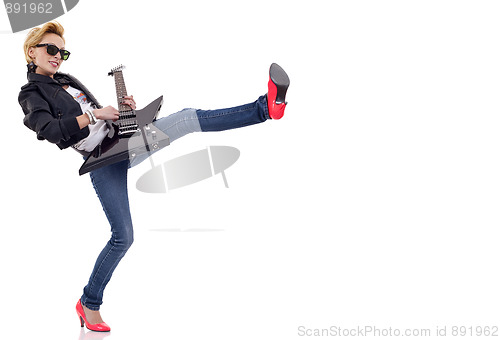 Image of kicking woman guitarist