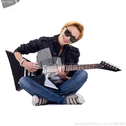 Image of playing guitar seated