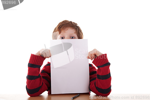 Image of kid holding a white sheet of paper in his hand