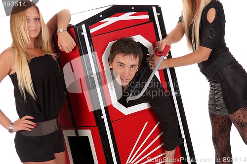 Image of Magician performance and two beauty girls in a magic box with ha