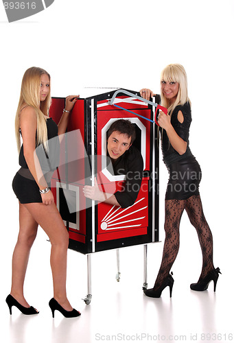 Image of Magician performance and two beauty girls in a magic box with ha