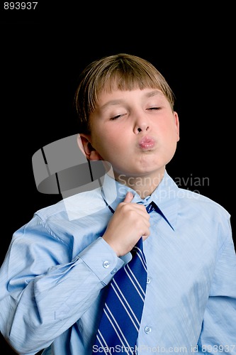 Image of School boy adjusting tie