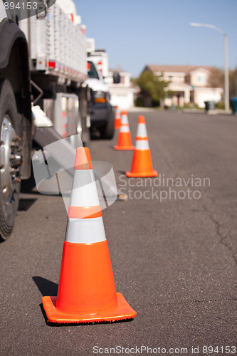 Image of Orange Hazard Cones and Utility Truck in Street