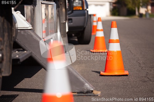 Image of Orange Hazard Cones and Utility Truck in Street