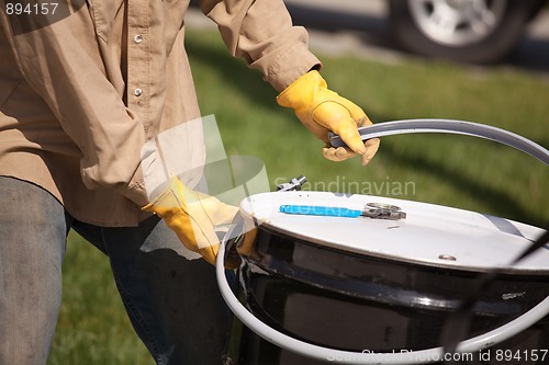 Image of Worker Opening or Sealing Utility Drum