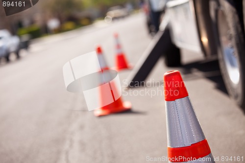 Image of Orange Hazard Cones and Utility Truck in Street