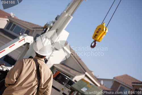 Image of Utility Worker Navigating Remote Crane
