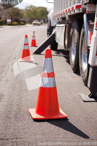 Image of Orange Hazard Cones and Utility Truck in Street