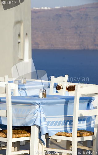 Image of classic Greek island restaurant furniture with view of the volca