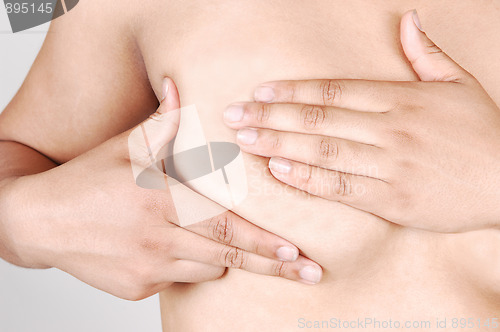 Image of Girl examining her breast.