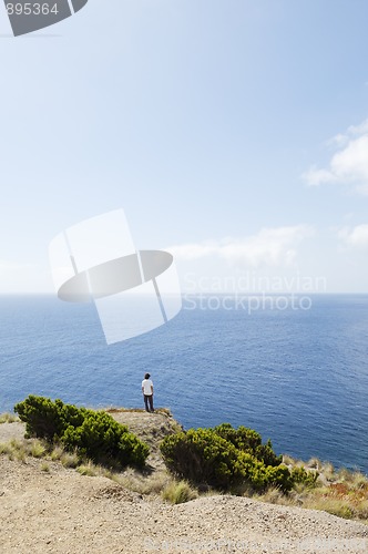 Image of Young man looking at sea