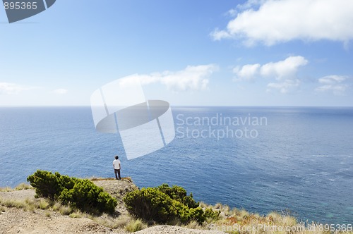 Image of Young man looking at sea