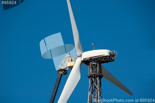 Image of Man repairs windmill