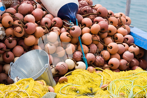 Image of Fishing tackle: net, bucket, buoy on the boat desk 