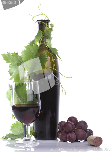 Image of Glass red wine and bottle with grape´s leafs