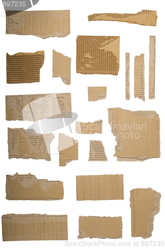 Image of Pieces of torn brown corrugated cardboard, Isolated on White