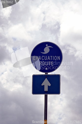 Image of Evacuation Route Sign in Florida against storm clouds