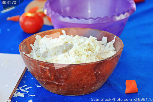 Image of Tasty kitchen. Wite cabbage in the wooden salad-dish