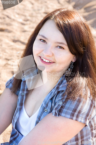 Image of Portrait of a young smiling girl with brown hair