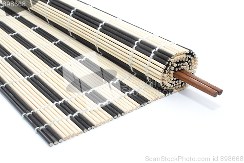 Image of Half-rolled bamboo mat with chopsticks