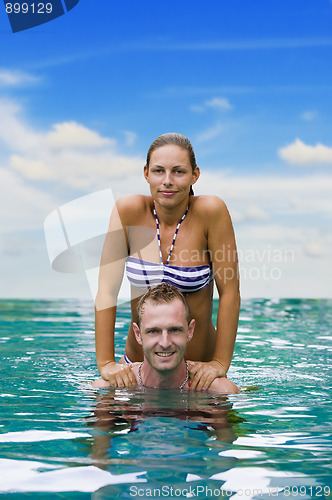 Image of playful couple in the water