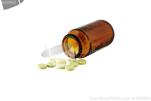 Image of The vitamins scattered from a bottle as tablets