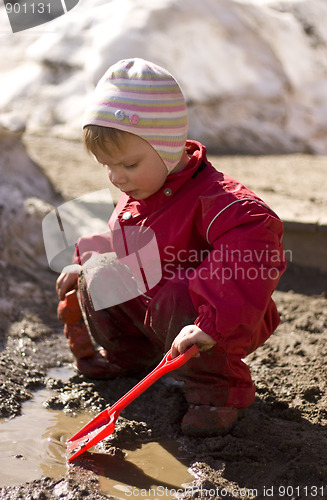 Image of Toddler playing in the mud