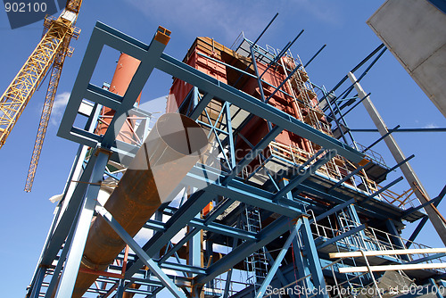 Image of cranes and beams on construction of industrial factory 