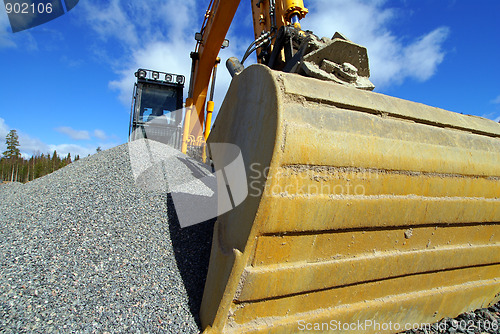 Image of excavator against blue sky    