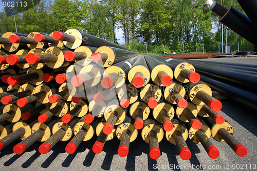 Image of PVC pipes stacked in construction site    