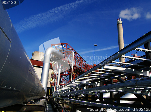 Image of Industrial zone, Steel pipelines and smokestack on blue sky    